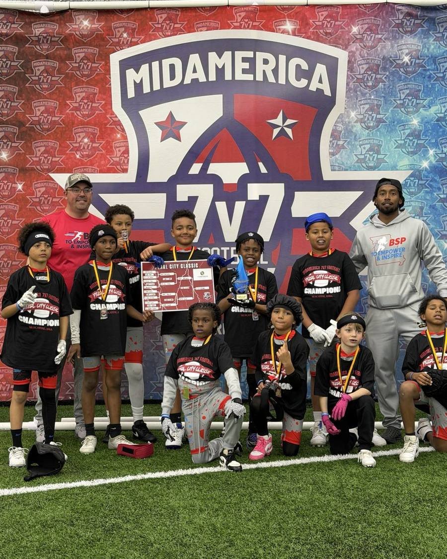 BSP youngest team posing with medals, a trophy and the bracket board